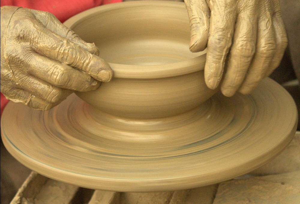 Raw clay wedging and kneading by potter hands