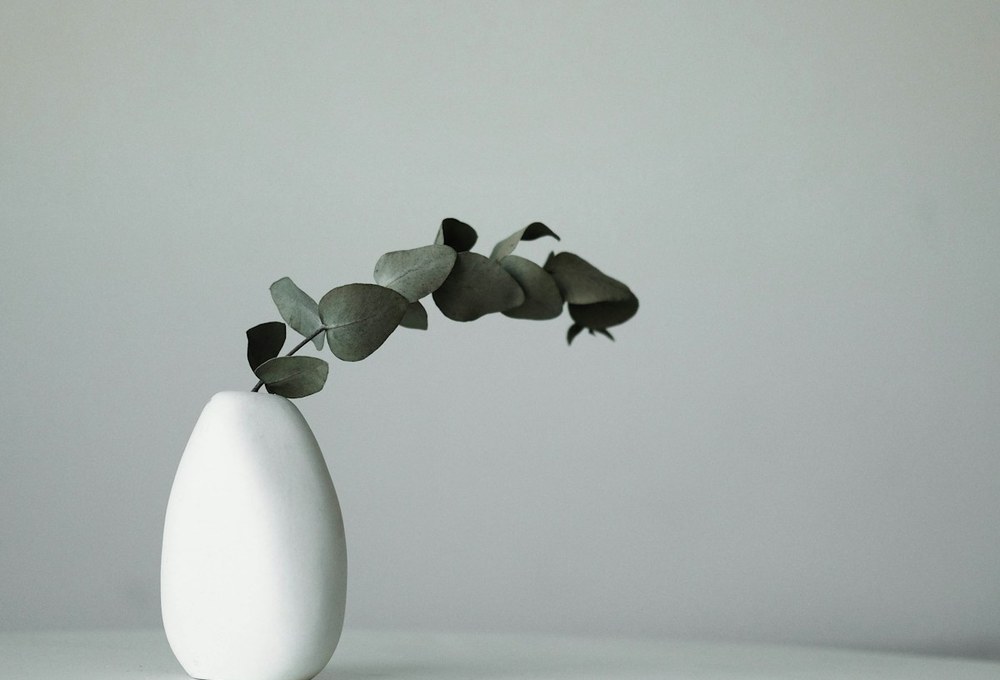 Hand-dipping ceramic bisqueware into glaze vat